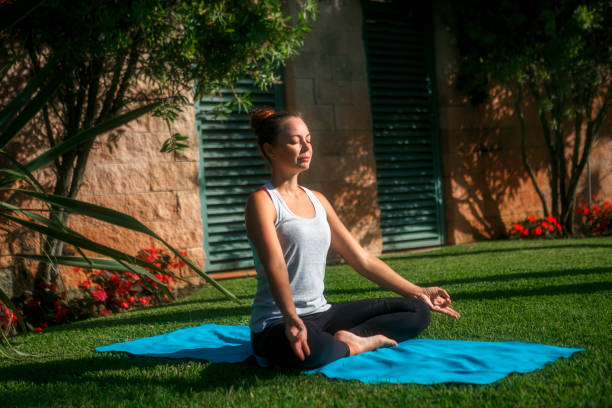 istock Woman does yoga exercise in a park 1270373523
