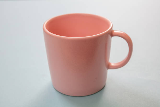istock Coffee mug pink color on pastel blue background. Hot beverage cup mockup template 1270374199