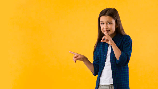 istock Girl pointing finger aside at copy space 1270374281