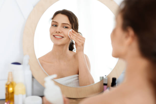 istock Cheerful girl cleaning her face, using cotton pads 1270374648