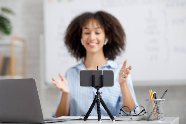 istock Modern education at home. Smiling african american girl explaining lesson on webcam 1270375944