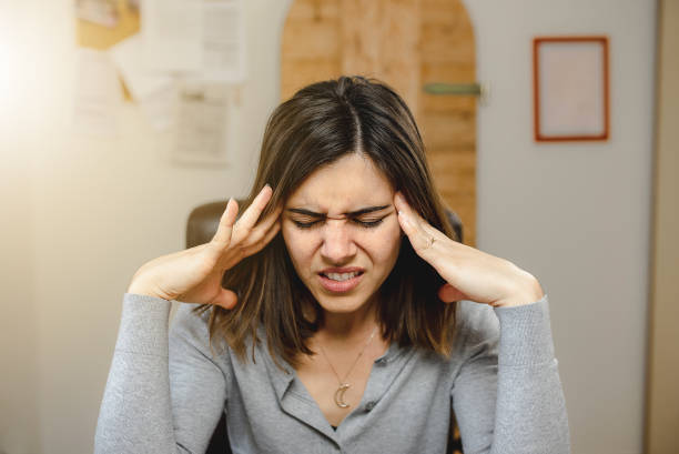 istock Young woman with headache during office work. 1270375981