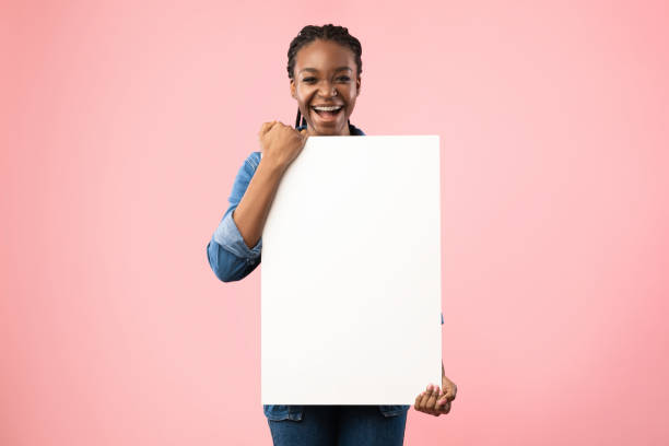 istock Joyful Black Girl Holding Empty White Board Posing In Studio 1270376105