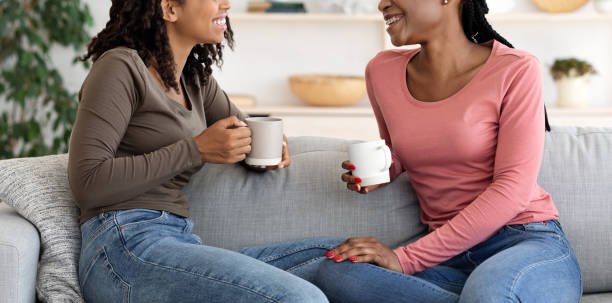 istock Cropped of two african ladies having conversation and drinking coffee 1270376190