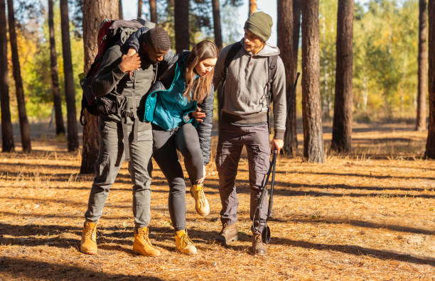istock Multiracial guys supporting their female friend with injured anckle 1270376830