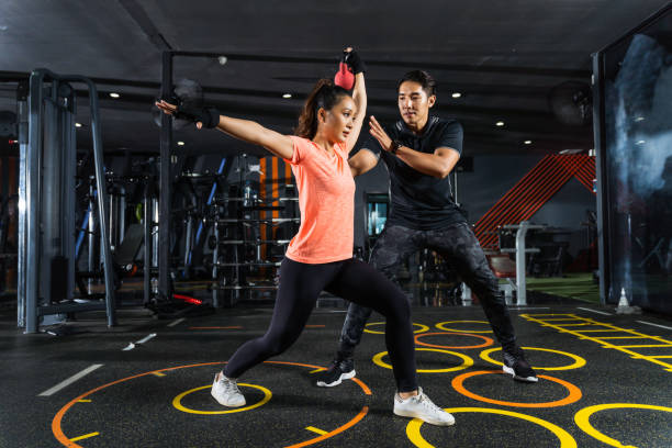 istock personal trainer recommends lifting weights in women 1270378714