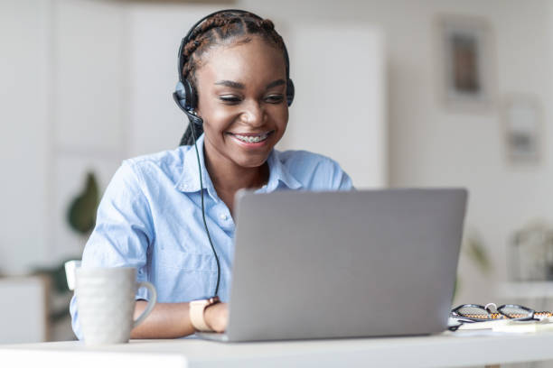 istock Hotline Operator. African woman call center worker in headset consulting client online 1270381448