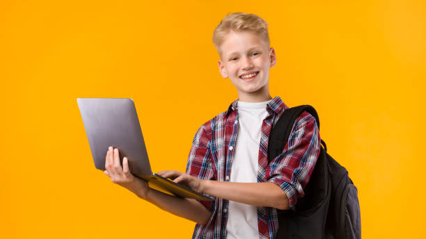 istock Happy guy holding laptop at yellow studio 1270382054