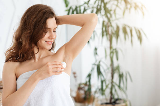 istock Young pretty woman using deodorant in bedroom 1270382214