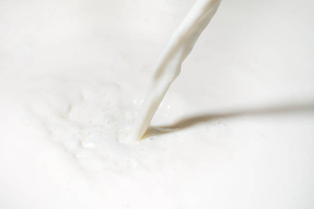 istock Drops of liquid milk pouring down or white drops with ripples 1270382292