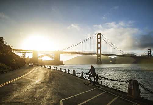Bicycle riding in San Francisco: commuter with racing bike by the Golden Gate Bridge
