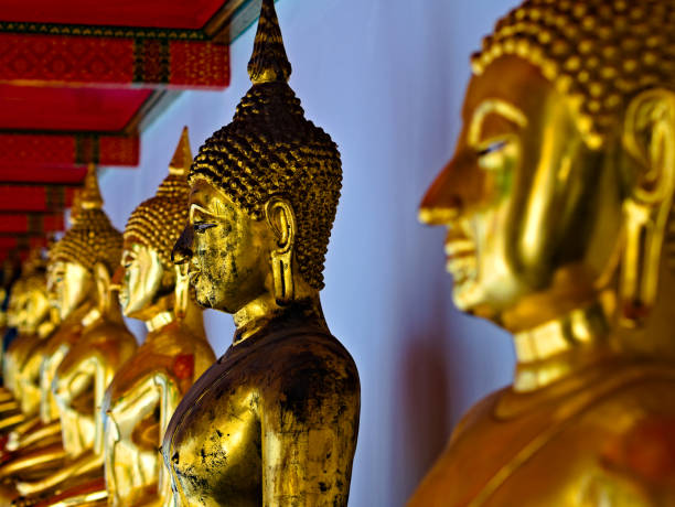 istock golden statues of Buddha, placed in a row 1270383395
