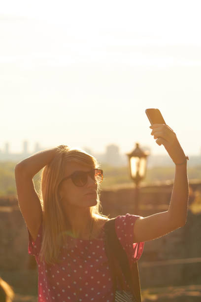 istock Young woman using modern smartphone in urban surroundings. 1270383887