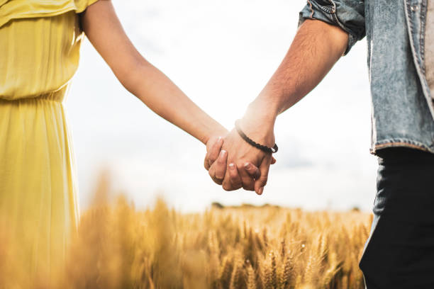 istock Couple holding hands in a wheat field at sunset 1270383927