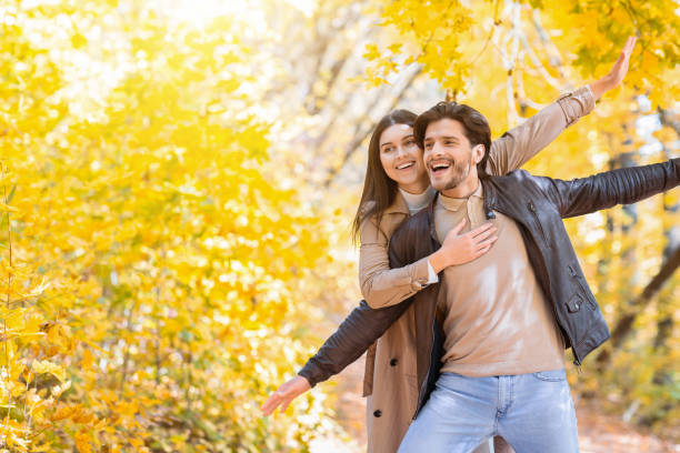 istock Happy lovers hugging and imitating airplane, autumn forest background 1270385047