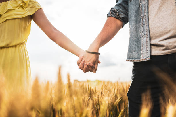 istock Couple holding hands in a wheat field at sunset 1270385508