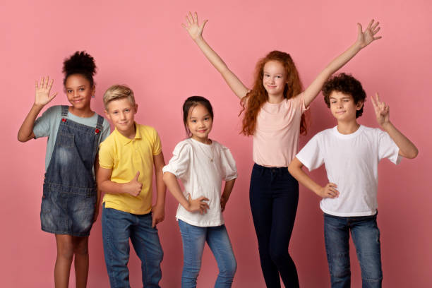 istock Cool multiethnic schoolchildren showing various gestures over pink background 1270387721