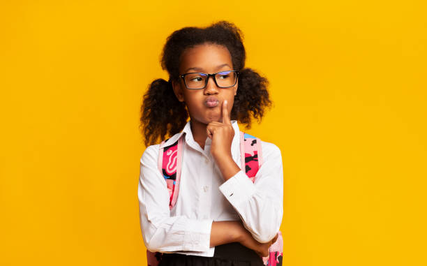 istock Pensive Black School Girl Thinking Posing In Studio, Yellow Background 1270388175