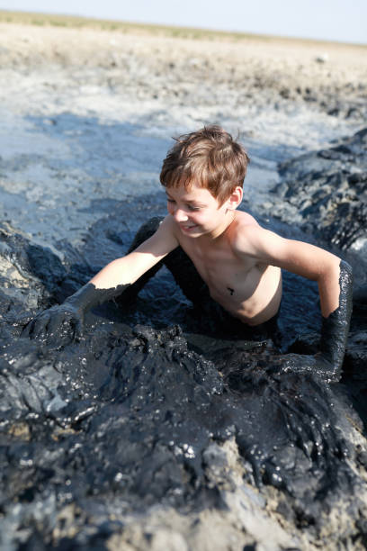 istock Child gets out of mud pool 1270389359