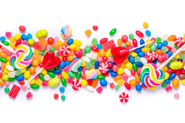 Assortment of multicolored candies on a stripe shape on white background