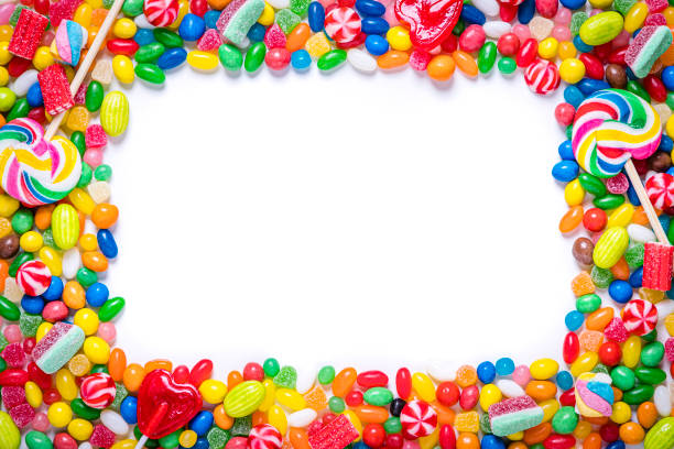 Assortment of multicolored candies on a frame shape with copy space Top view of an assortment of multicolored candies, lollipops and jelly beans background. All the candies are at the borders of the image making a frame shape and leaving a useful copy space at the center of the image on a withe background.  Studio shot taken with Canon EOS 6D Mark II and Canon EF 24-105 mm f/4L candy jellybean variation color image stock pictures, royalty-free photos & images