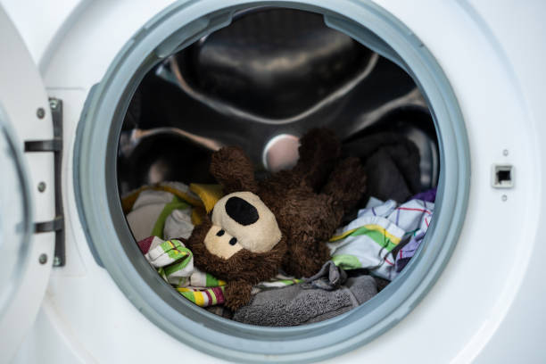 istock A brown teddy bear with dirty laundry in a washing machine 1270389966