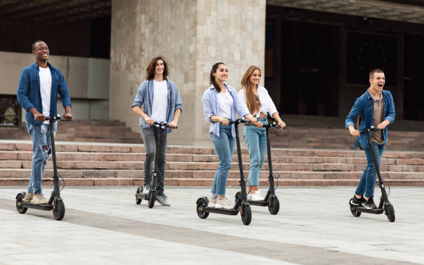 istock Five friends having pleasant ride on motorized kick scooters 1270391282