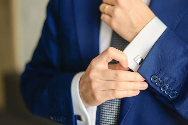 istock Groom or businessman fasten cufflink 1270391291