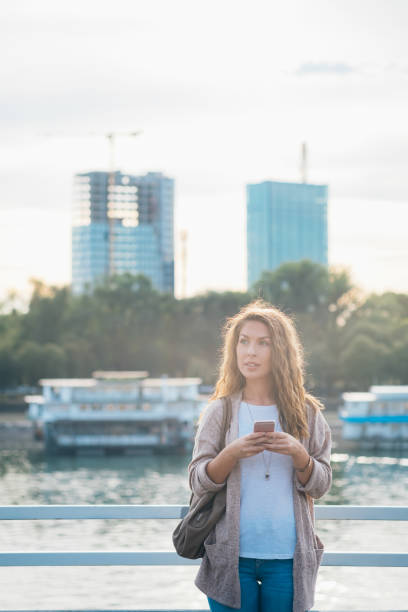 istock Young woman using phone outside stock photo 1270391454