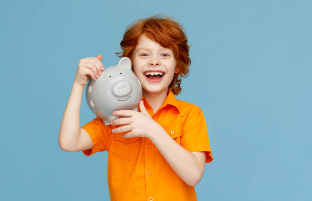 istock Optimistic boy with piggy bank 1270392273