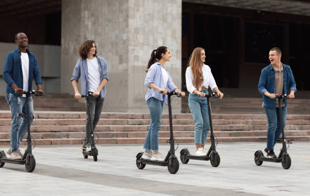 istock Five happy friends spending time in park and riding 1270392340