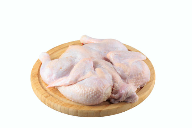istock raw chicken carcass on the cutting board isolated on white background. 1270392766