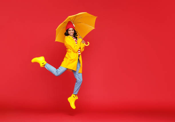 istock Happy ethnic female jumping with umbrella 1270392871