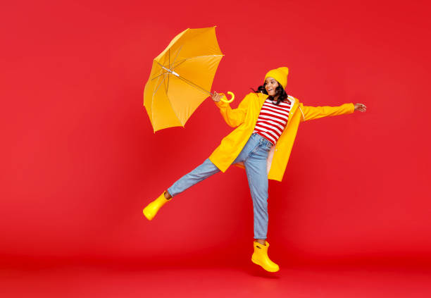 istock Cheerful ethnic woman flying on umbrella 1270393622
