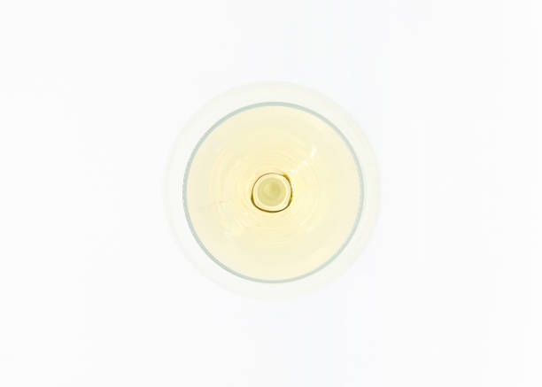 Glass of white wine from top in white background