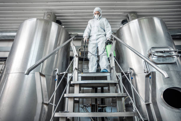 istock Man in protective suit, disinfection brewery kettles, free space 1270395304