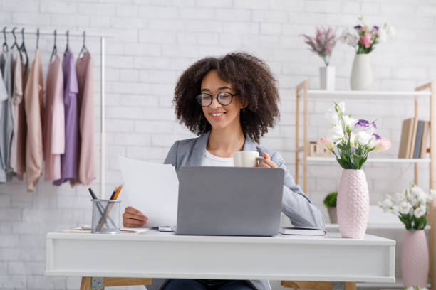 istock African american woman checks documents, drinking coffee, sits at table 1270395871