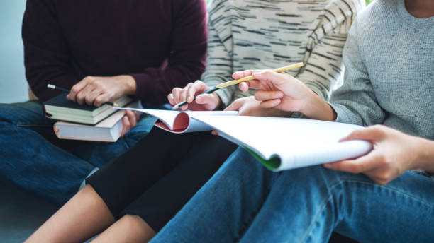 istock young students tutoring and  catching up workbook with friends 1270395998