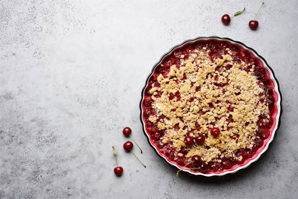 istock Cherry crumble with oatmeal crust in baking dish.  Gray background, top view 1270396007
