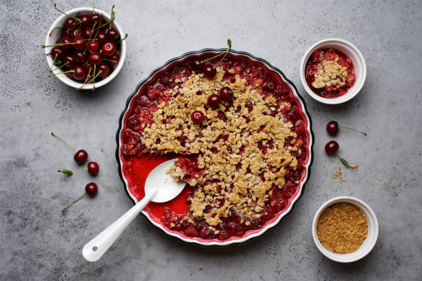 istock Cherry crumble with oatmeal crust in baking dish.  Gray background, top view 1270396016