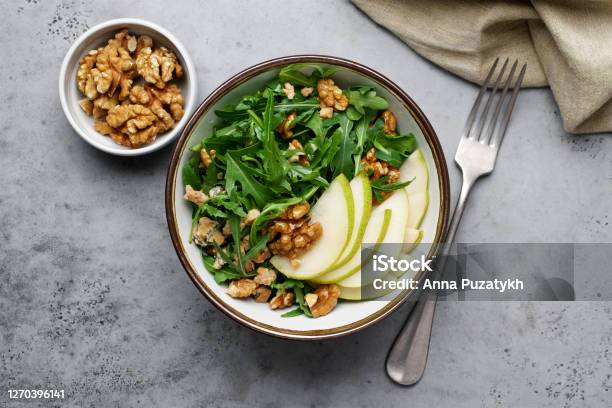Fruit Salad With Pears Arugula Walnuts And Roquefort Cheese Stock Photo - Download Image Now
