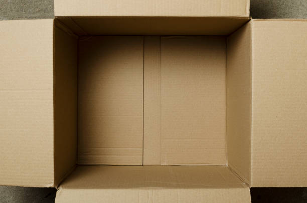 Top view of opened cardboard box and a little one with labe  in it