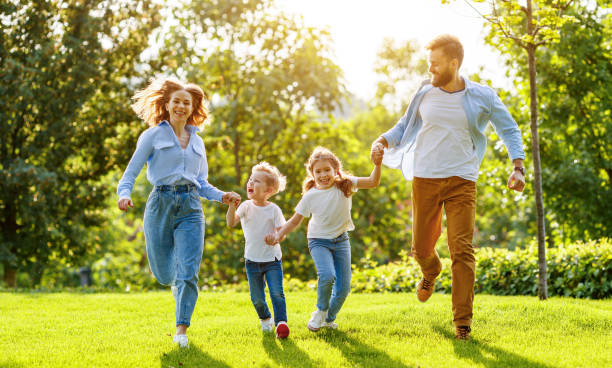 istock Happy family playing together in park 1270397715