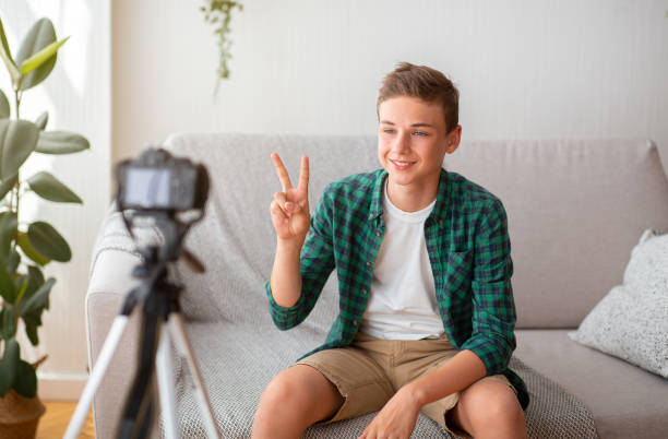 istock Famous teenager blogger broadcasting from home, using camera 1270398341