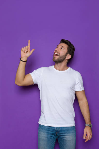 Handsome Man In White Shirt Is Pointig Up, Looking And Talking