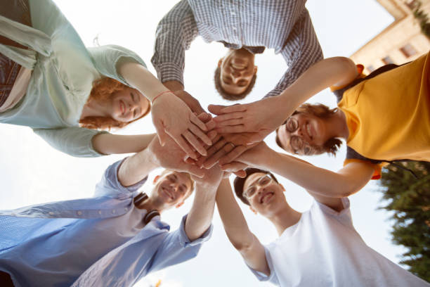 istock Students Holding Hands Standing In Circle Outdoors, Bottom-View Shot 1270400773
