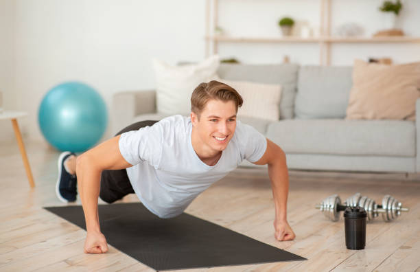 istock Quarantine sport. Muscular guy doing push-up exercises on fists 1270400978