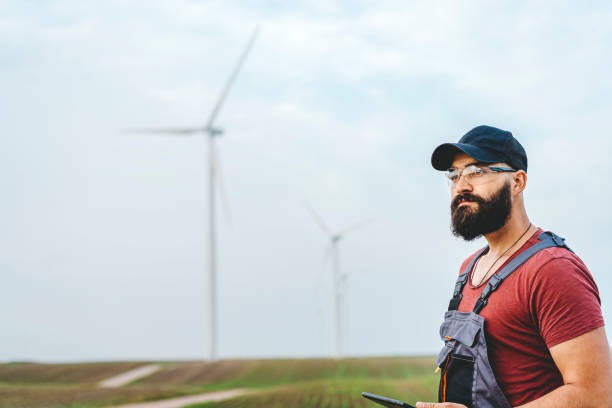istock Young maintenance engineer man working in wind turbine farm 1270401934