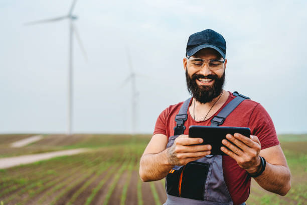 istock Young maintenance engineer man working in wind turbine farm 1270401935