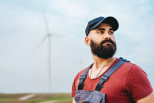 istock Young maintenance engineer man working in wind turbine farm 1270402025